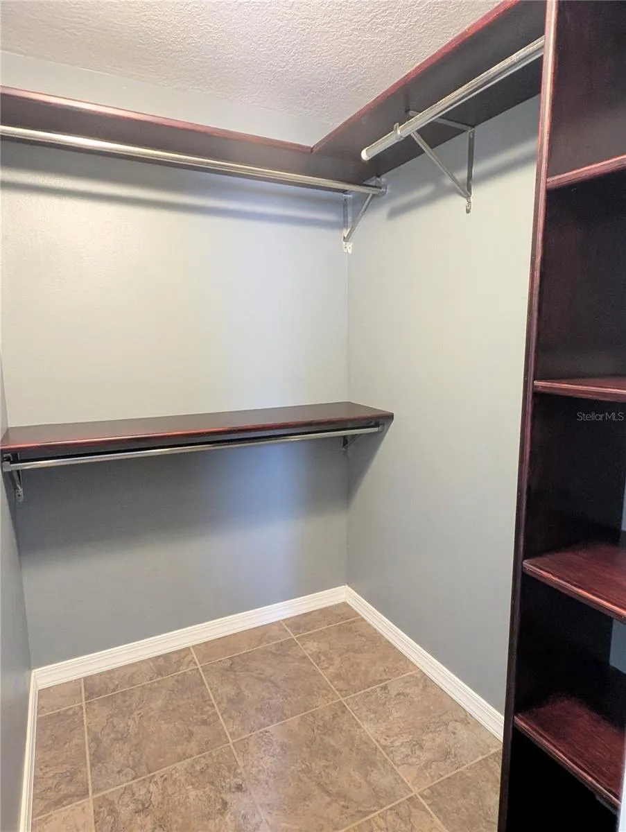 Primary walk-in closet with custom shelving