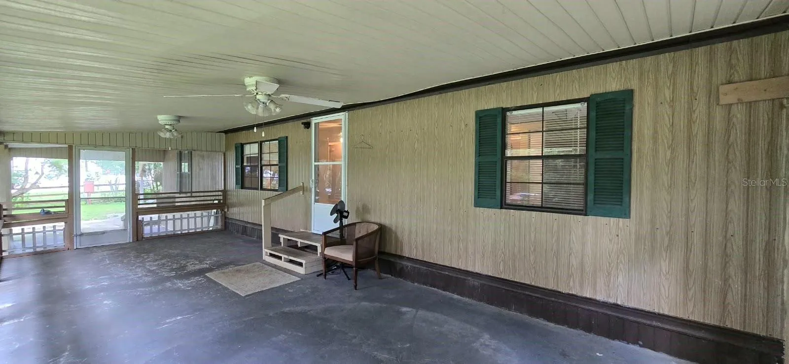 View from the other side of the screened-in porch on front of the home