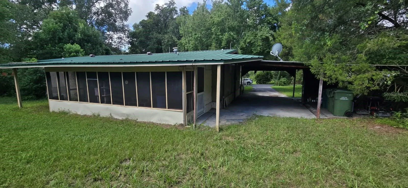 View from back corner of property, showing lanai and carport area