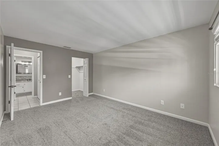 Bedroom #2--bathroom #2 is directly across from the bedroom and the walk-in closet can be seen to the right.