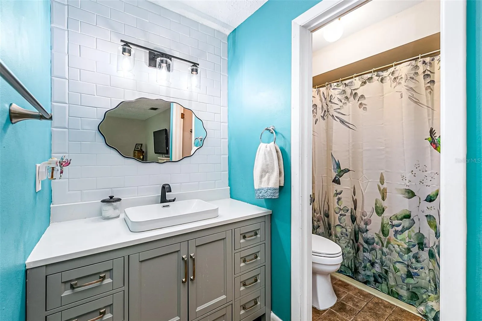 primary bathroom has just been upgraded with new tile and sink and updated cabinetry.  The shower (no tub) has new fixtures as well.