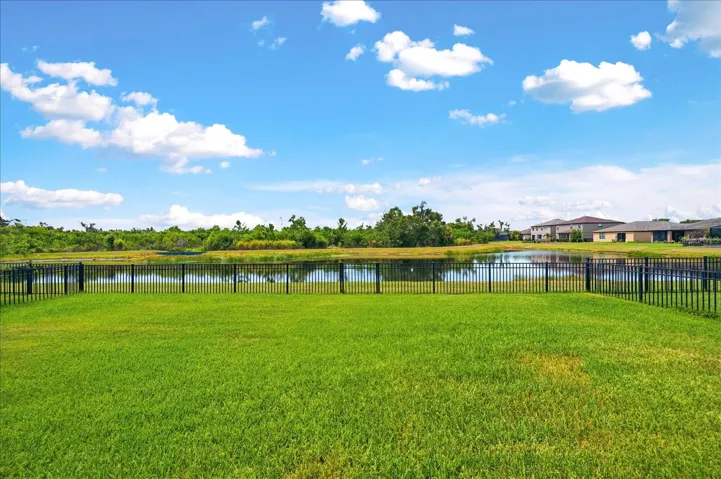 Large fenced backyard with water & preserve views