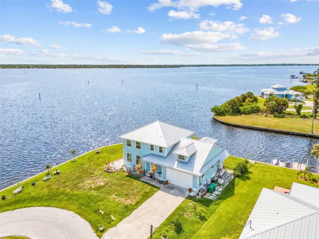 Aerial view of the home with the canal and river behind the property.