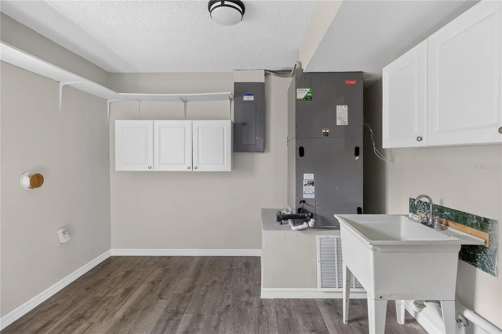 HUGE laundry room with shelving and utility sink.