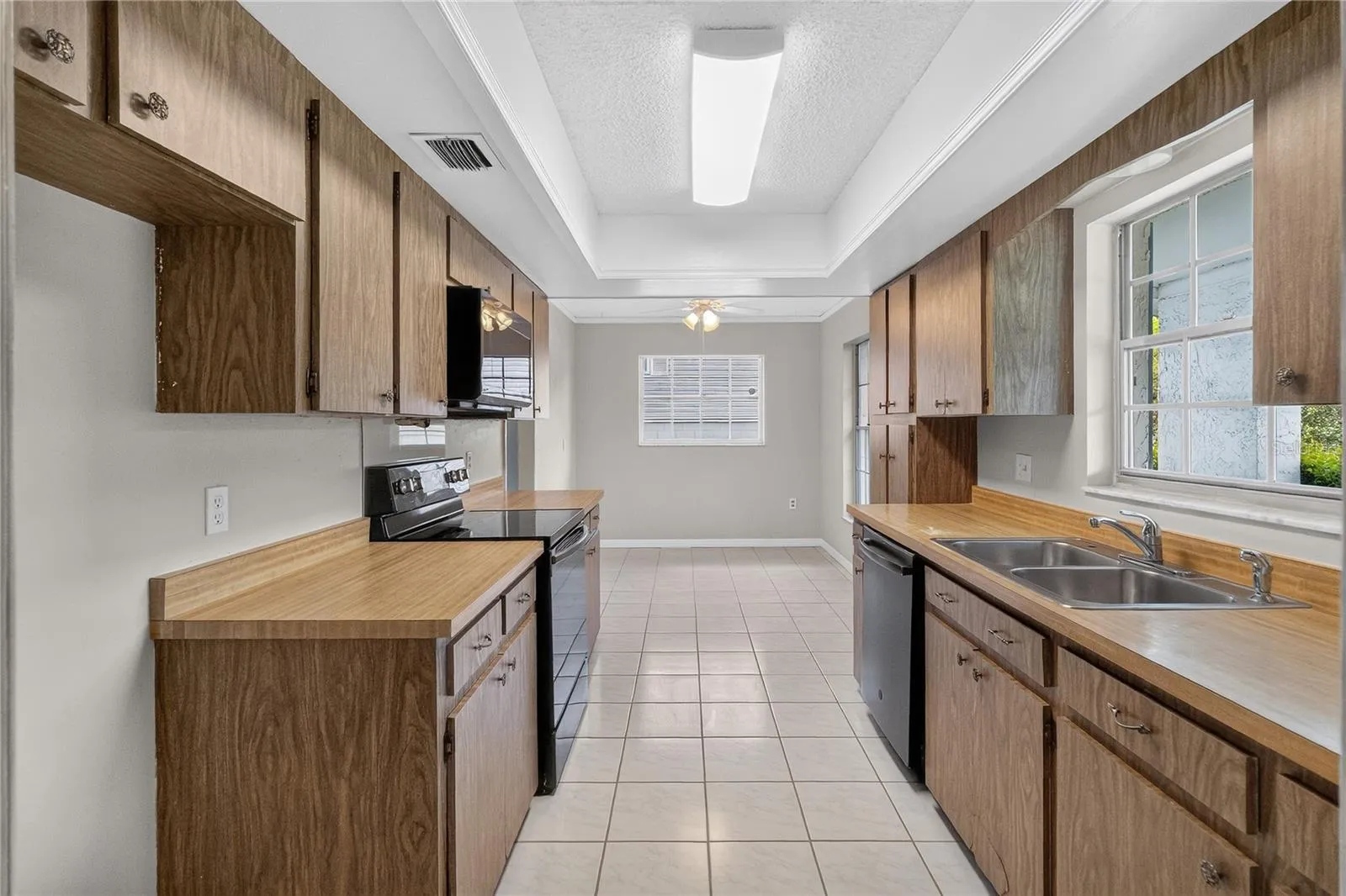 Kitchen is light and bright - having three (3) windows with a window over the kitchen sink.   A front-facing kitchen sink window brings in natural light and lets us keep an eye on what’s happening in the front of our home — deliveries, guests arriving, kids playing.