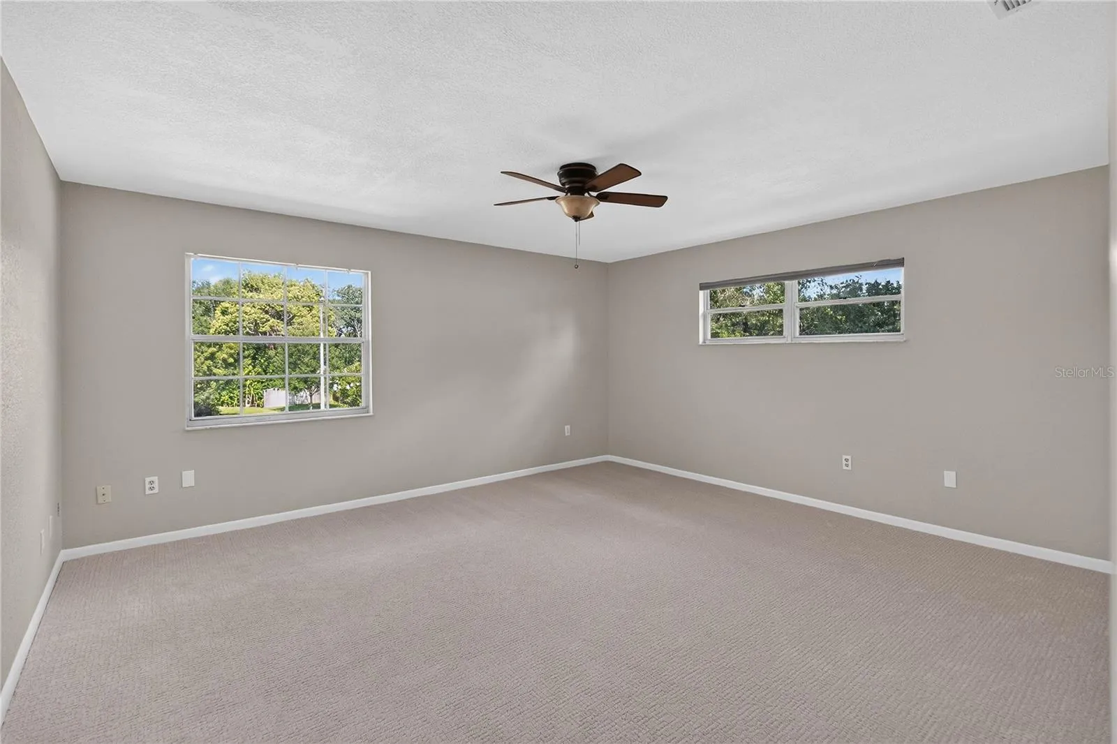 View 2 - Primary Bedroom (15x16) with en Suite bathroom, dual closets, light & bright with two windows