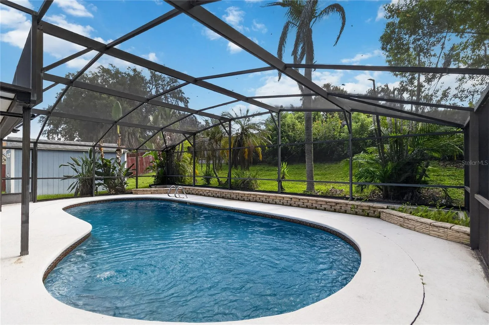 Pool view brings tranquility and calm.  10x16 Tuff Shed to the left (added shelves & hurricane protection)