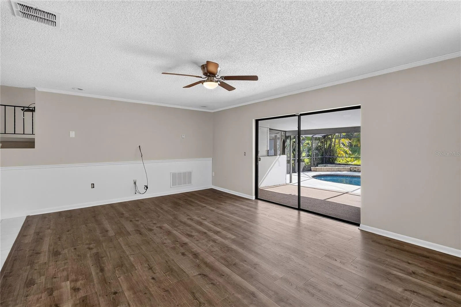 View 2 Living Room (14x20) is open and bright with pool views