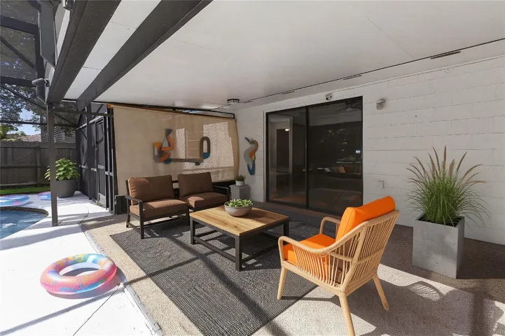 Shaded living space in the outdoor back patio.  Enjoy additional living spacing connecting the indoor and outdoors. (virtual furnishings)