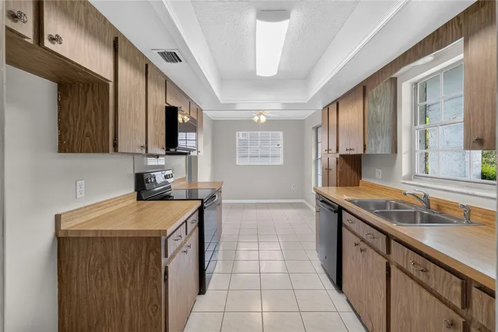 Kitchen is light and bright - having three (3) windows with a window over the kitchen sink.   A front-facing kitchen sink window brings in natural light and lets us keep an eye on what’s happening in the front of our home — deliveries, guests arriving, kids playing.