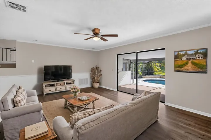 Living Room (14x20) is open and bright with pool views (virtual furnishings)