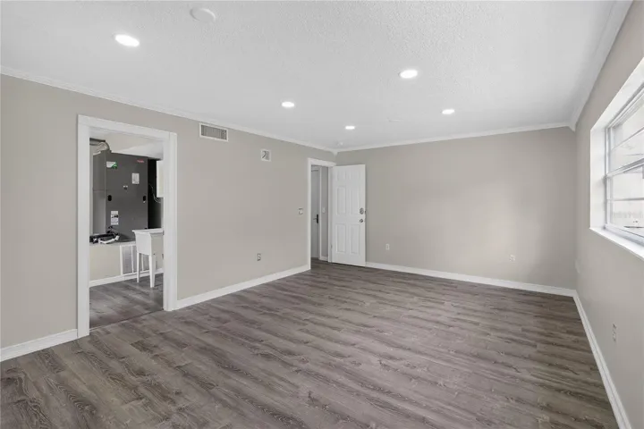 View 2 - Bedroom #5, en Oversized ground floor bedroom offers flexible use — ideal as a guest suite, craft studio, home office, fitness room.  This multi purpose space has GREAT VALUE and not just “another bedroom.”