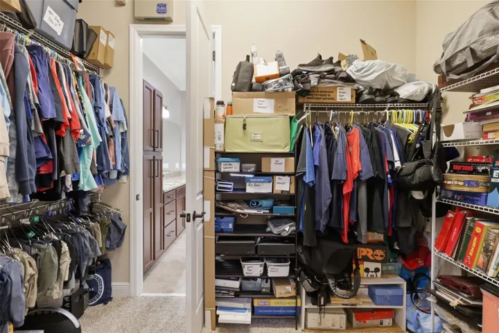 Primary Bedroom Closet with access to the laundry room.