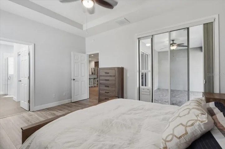 Primary suite w/ sliders leading to scr patio