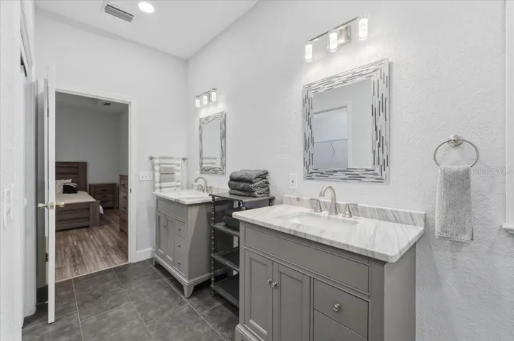 Beautiful tile & quartz countertops in primary BA
