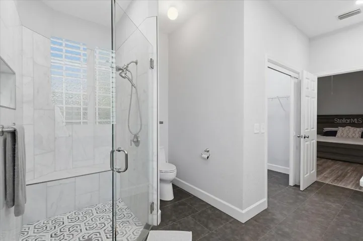 Nicely tiled shower w/ glass enclosure