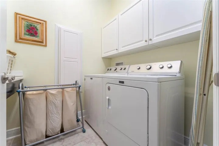 Laundry Room with Maytag Washer &amp; Dryer, Built in Cabinetry, Laundry Sink &amp; Folding Table