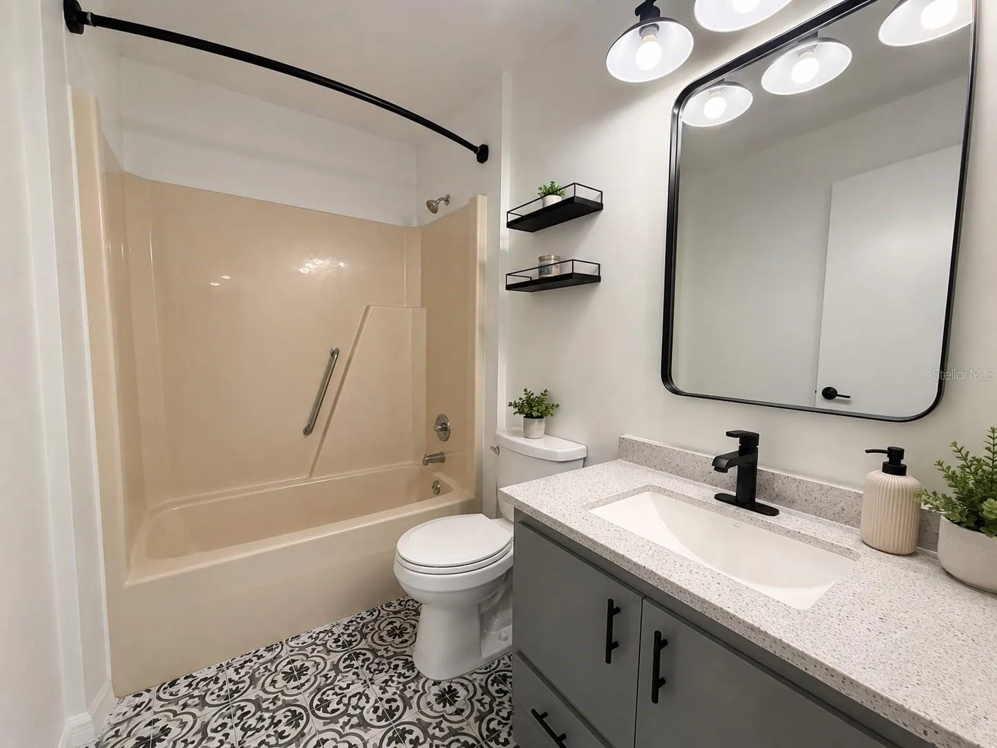 guest bathroom new vanity, mirror, light fixture, newer toilet and tile.