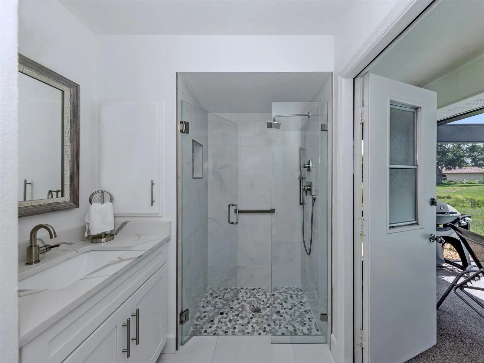 The second full bath doubles as a pool bath and is shared by both the second and third bedrooms