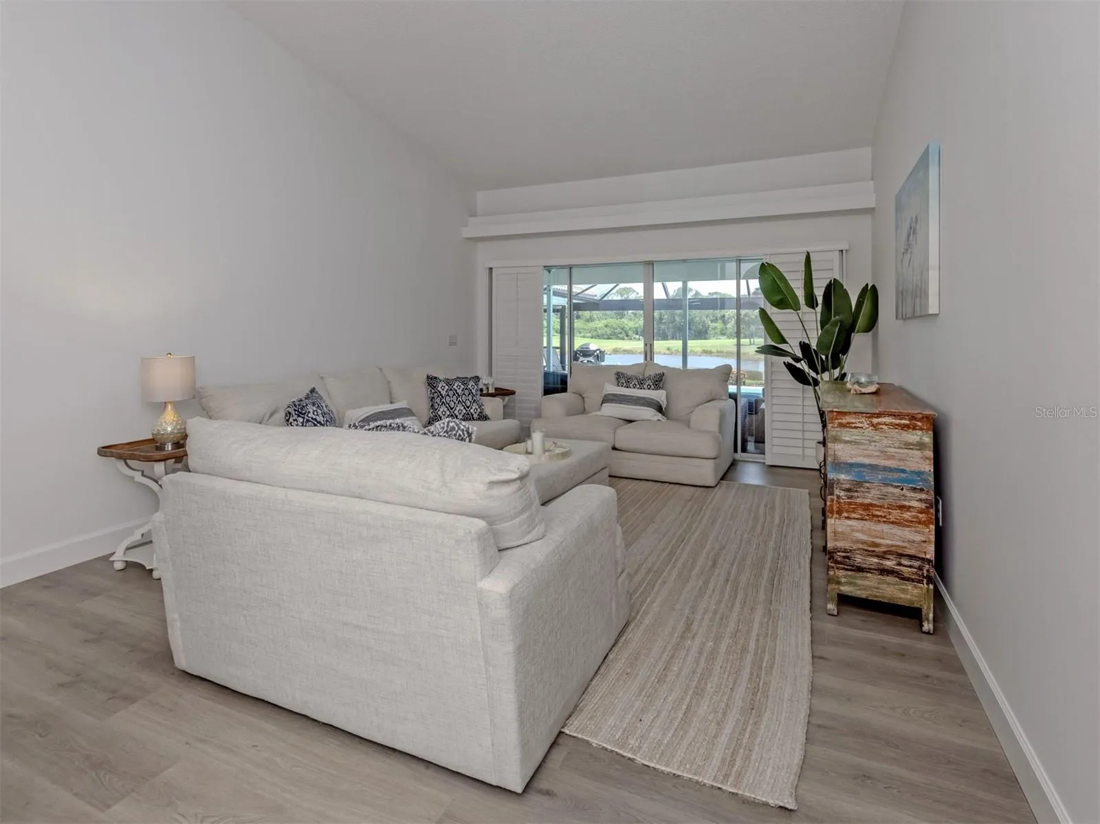 The formal living room includes sliding glass doors that open to the lanai
