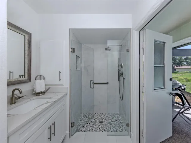 The second full bath doubles as a pool bath and is shared by both the second and third bedrooms