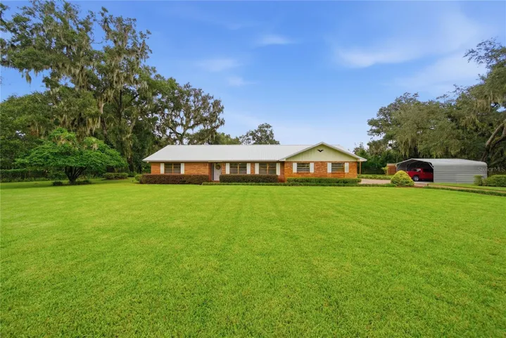 On 1.36 acres with lush landscaping & 3 fruit trees.