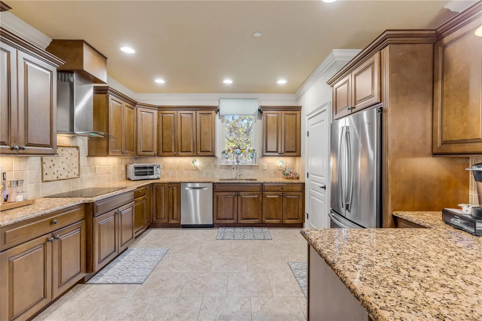 wood cabinets, granite countertops, tile backsplash