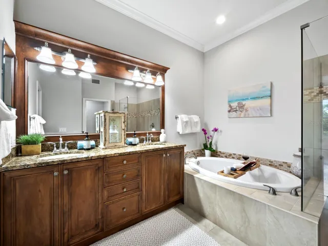 Primary Bathroom with dual sinks, separate soaking tub, Large enclosed glass shower and water closet.