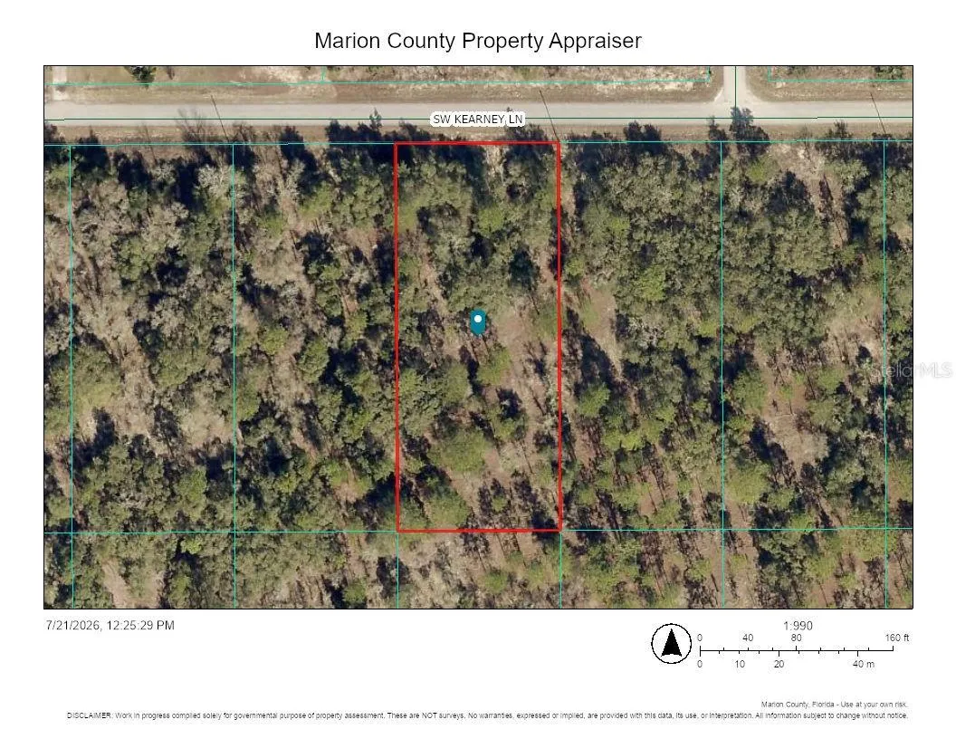 Bird's-eye aerial view of parcel and paved road access.