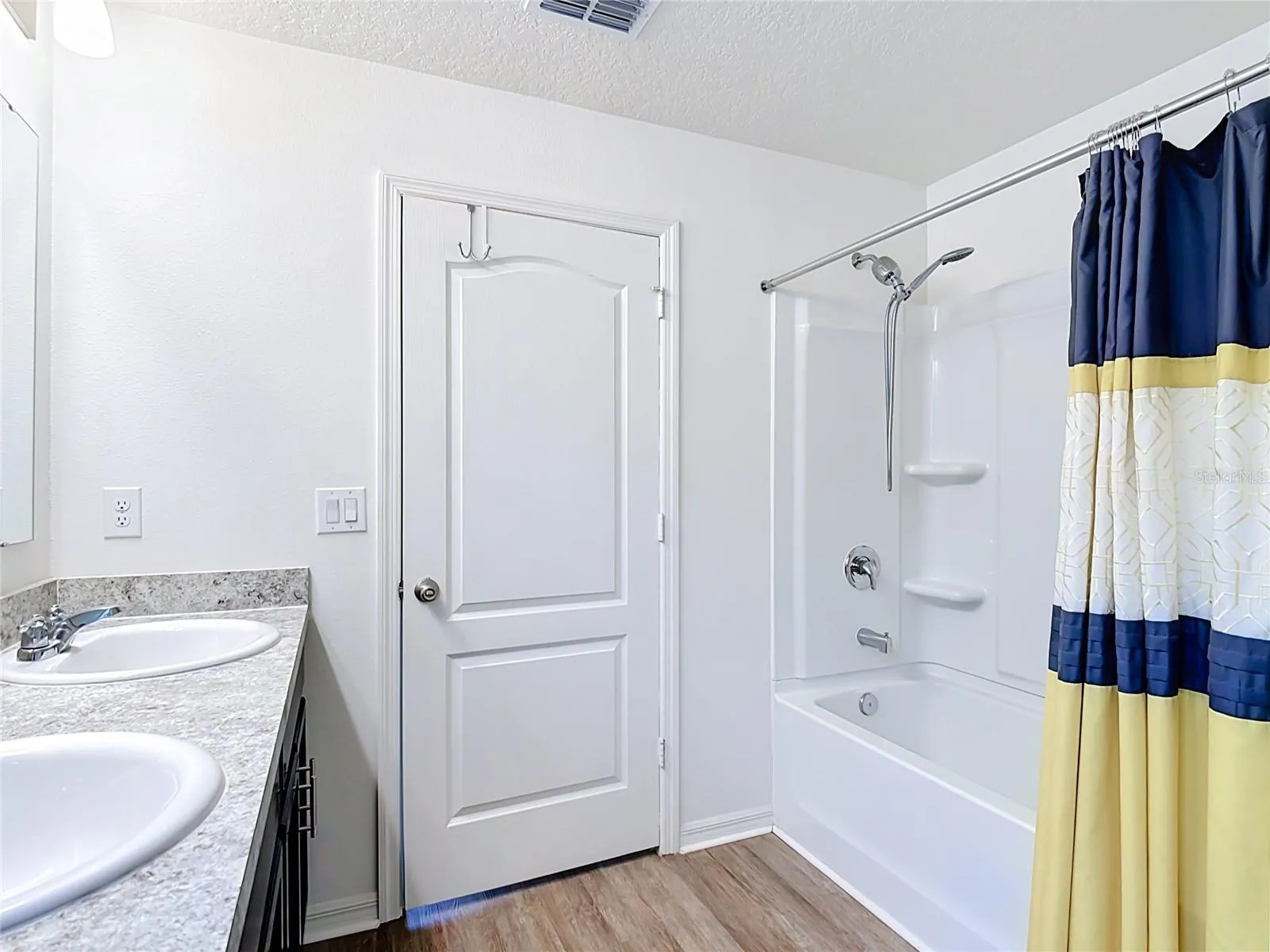 En-suite bathroom with linen closet and bathtub