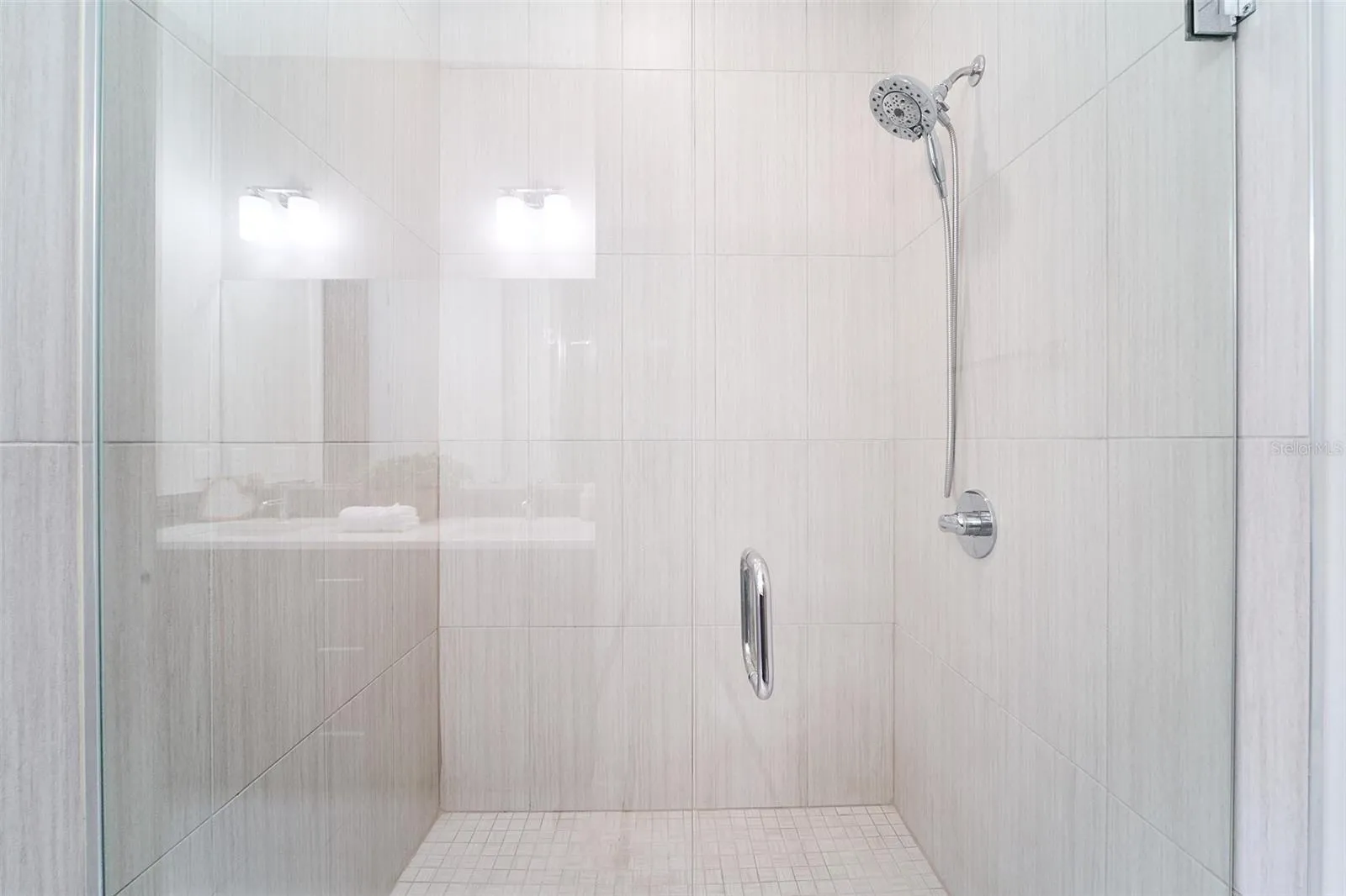 primary bathroom tiled walk in shower w glass door
