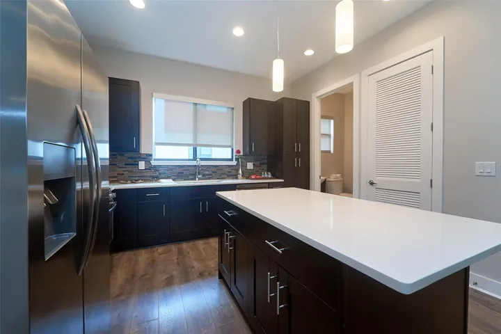 kitchen with island and Quartz counters