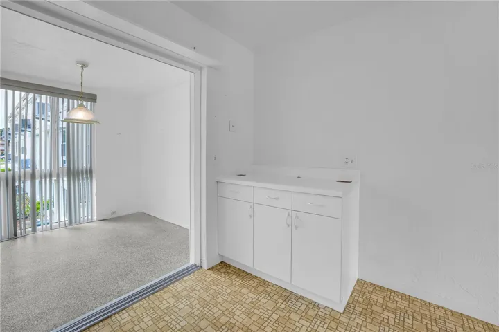 View from kitchen to sunroom (with extra counter/storage space)