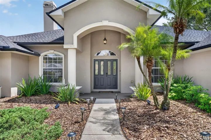 Thoughtfully designed landscaping and this spacious entryway invite guests into the home!