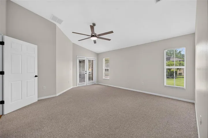 This primary bedroom is a dream with large spaces and an entrance to the backporch.