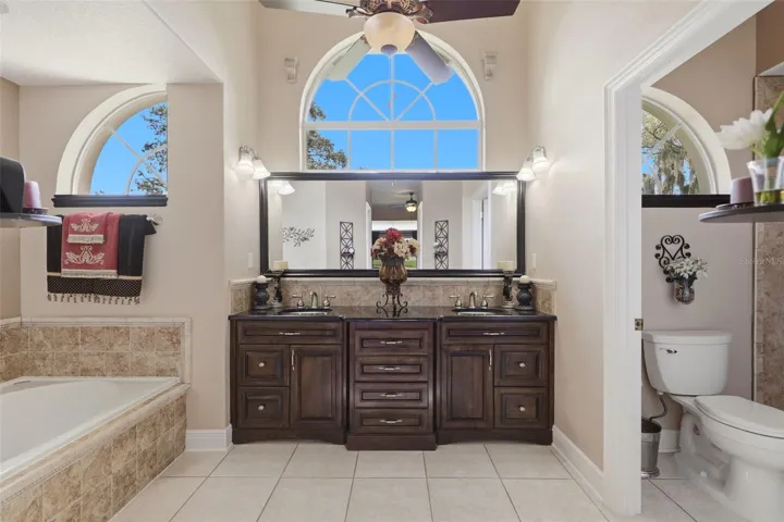 primary bathroom with custom maple cabinetry
