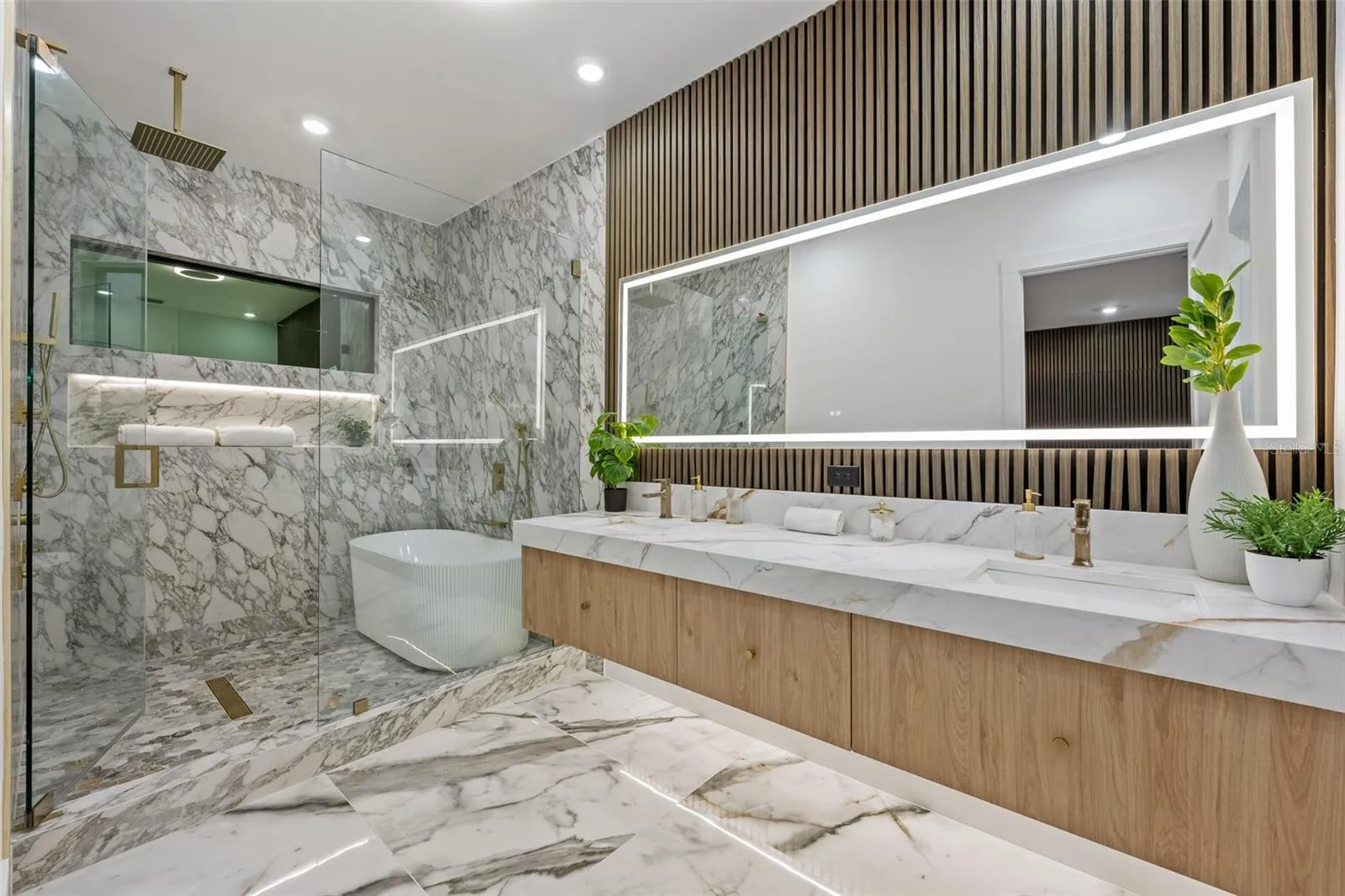 No matter the time of day this primary bath is gorgeous.