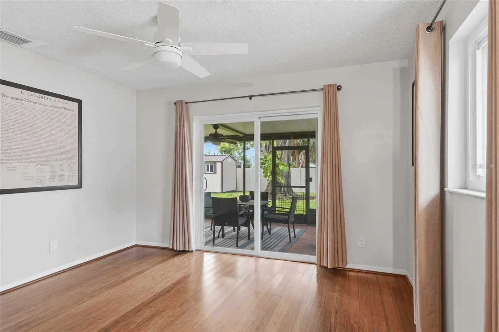Primary Bedroom with entry to screened in back porch and yard