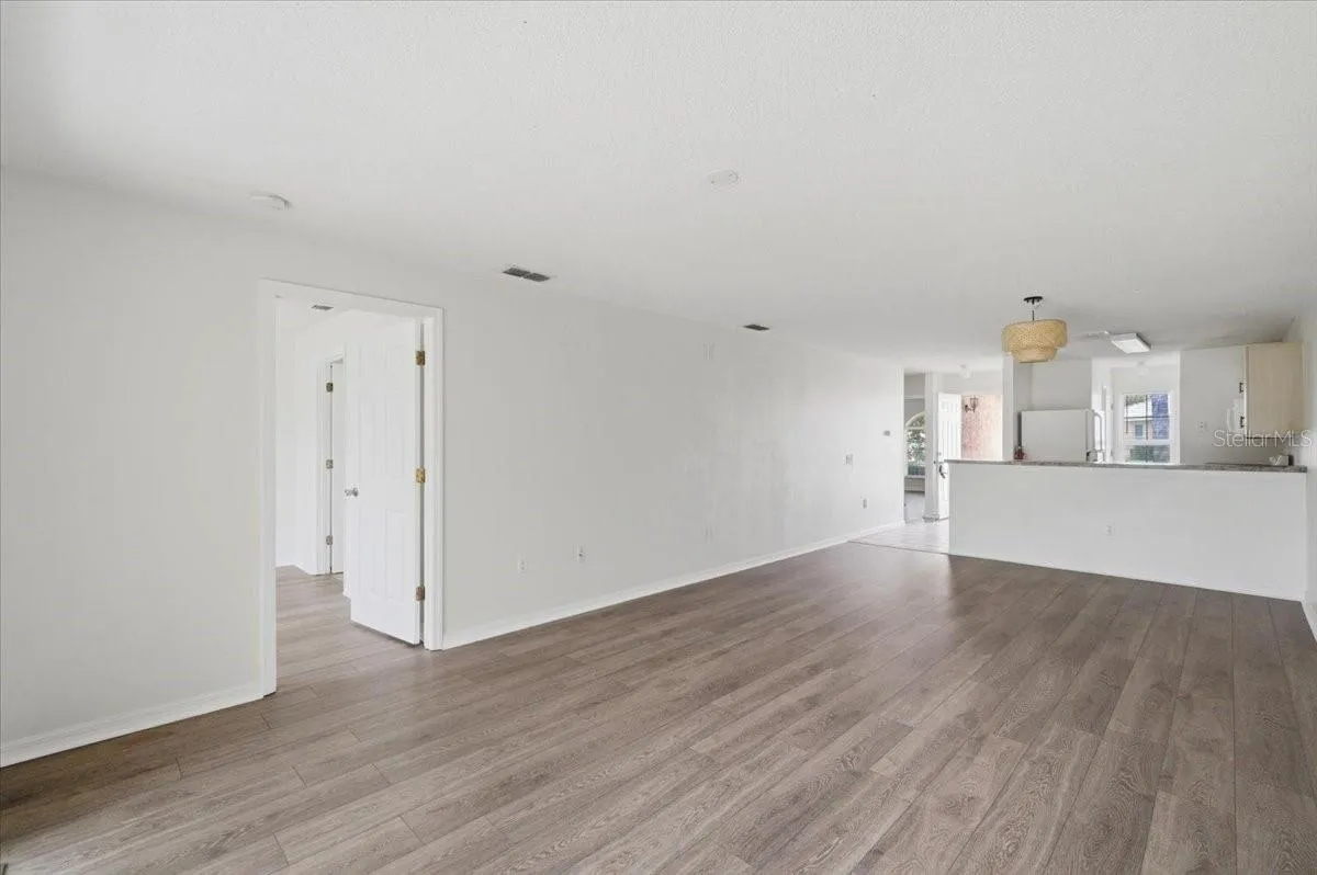 Open concept floor plan featuring a spacious kitchen that overlooks the inviting living room, perfect for seamless entertaining and daily living.