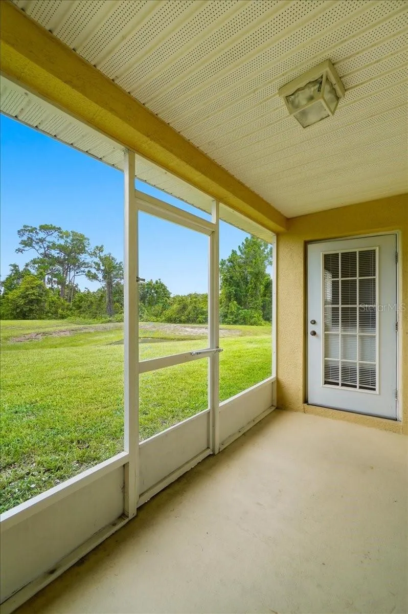 Enclosed rear porch offering peaceful privacy with no rear neighbors; an ideal setting for quiet morning coffee or relaxing evening dinners.