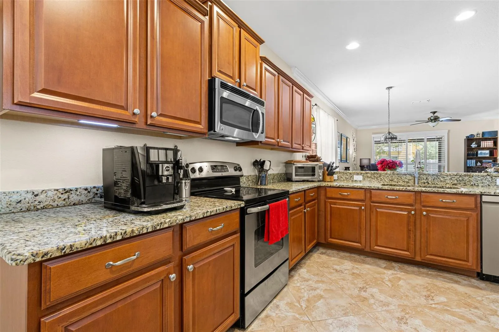 Solid wood cabinetry, granite counters and recessed lighting give the kitchen a warm, polished look with plenty of workspace and storage.