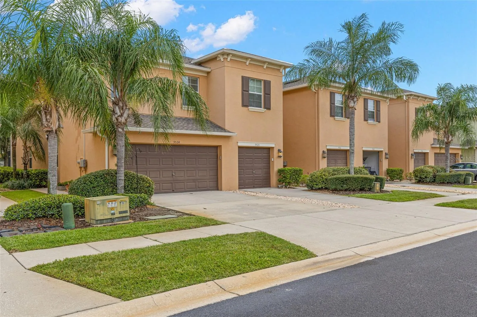 The stucco exterior, architectural rooflines and mature landscaping create a warm Florida look, while the two-car garage adds the space townhome buyers rarely find.