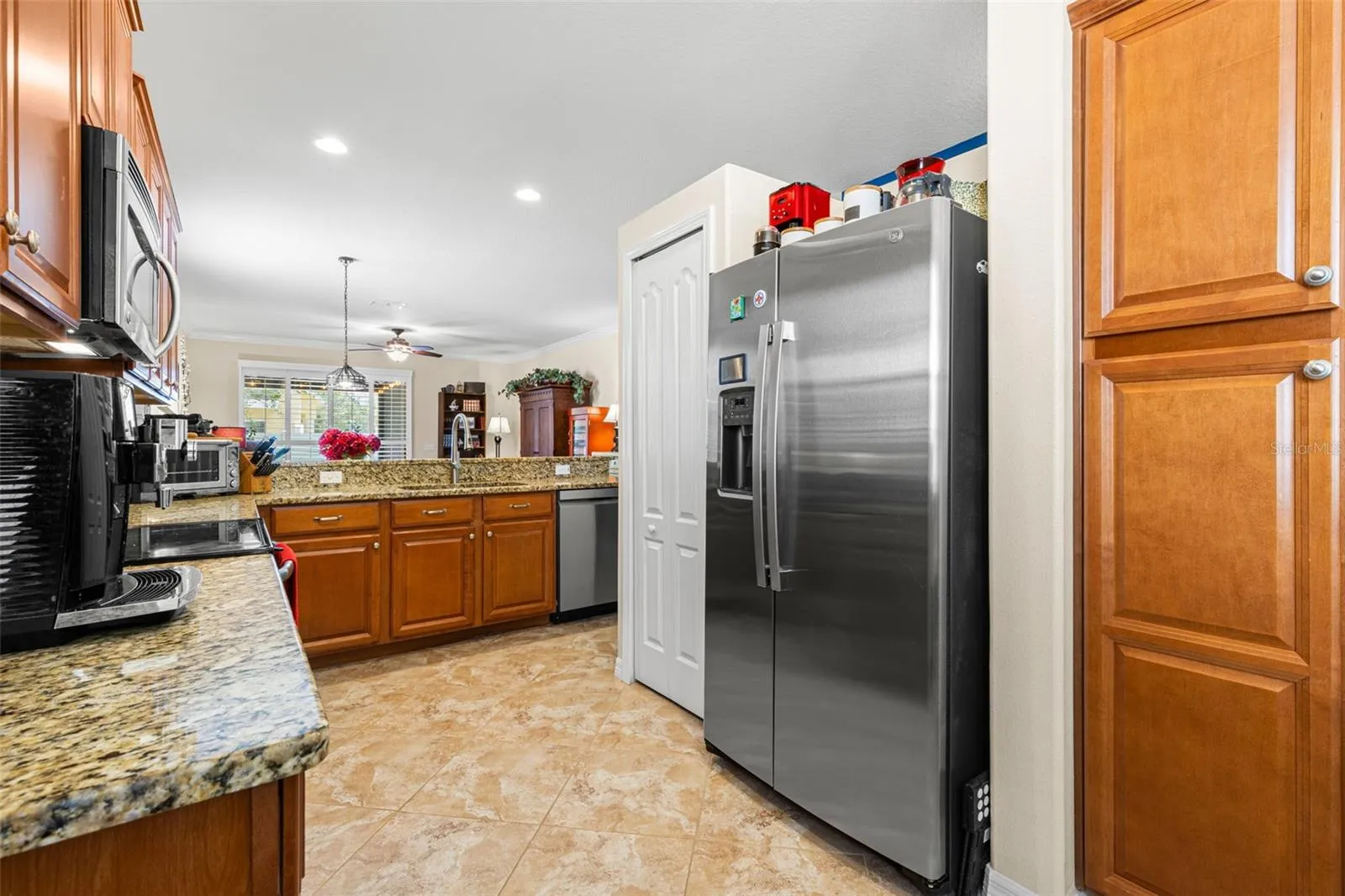 The kitchen includes a pantry and stainless appliances, including a 2026 GE refrigerator and 2025 LG dishwasher, with the range and microwave completing the suite.