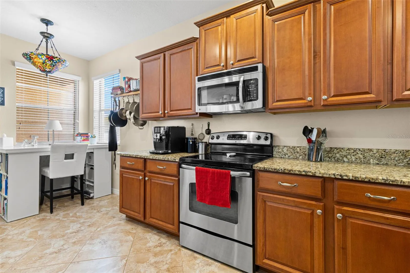A windowed corner brings natural light into the kitchen and creates an easy spot for a small desk, coffee station or casual seating.