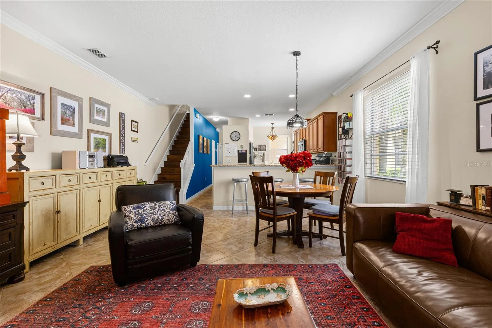 A large window brightens the dining area, which feels clearly defined while remaining open to both the living room and kitchen.