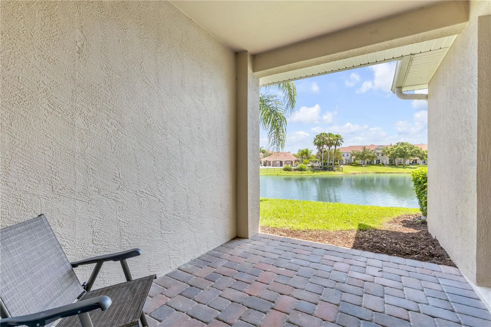 Back patio overlooking pond with fountain