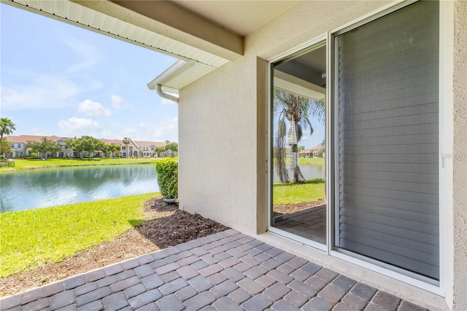 Back patio overlooking pond with fountain