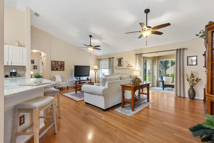 Living room with hardwood floors and vaulted ceilings.