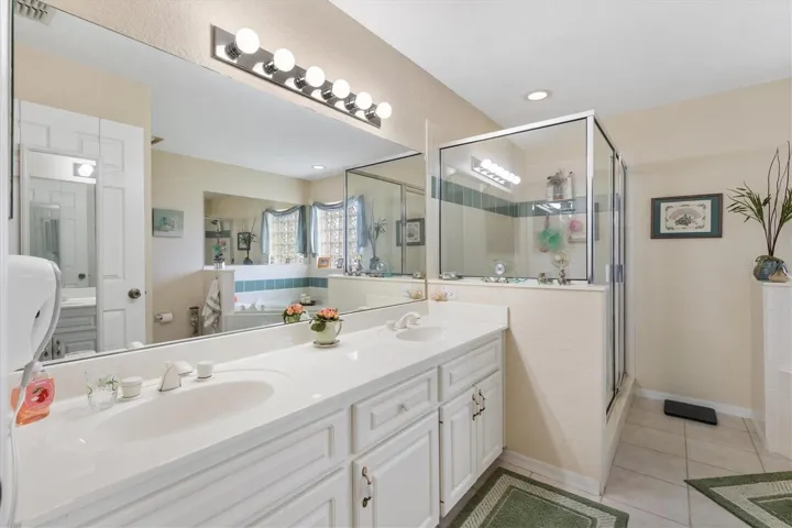Dual sinks in vanity, large walk-in shower, soaking tub.