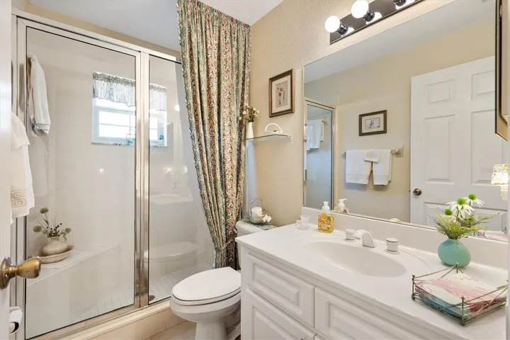 Second bathroom with walk-in shower and built-in seat.